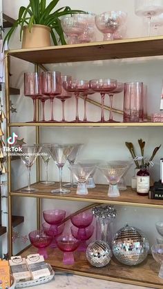 a shelf filled with lots of wine glasses