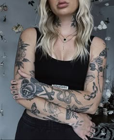 a woman with tattoos on her arms and chest