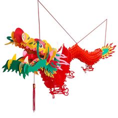 a red and yellow dragon kite flying through the air