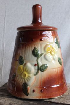 a ceramic vase with flowers painted on it