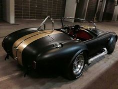 a black and gold sports car parked in a garage