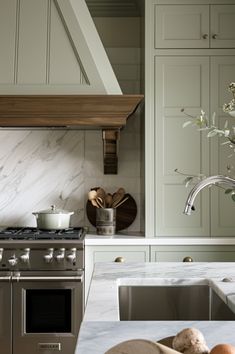 a kitchen with marble counter tops and stainless steel appliances