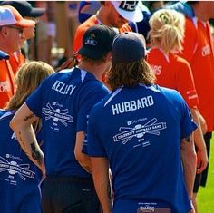 a group of people in blue shirts standing next to each other