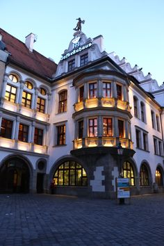 the building has many windows and lights on it's roof, along with a clock tower