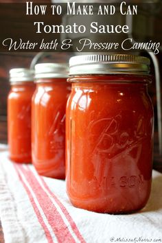 three jars filled with tomato sauce sitting on top of a towel