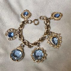 "Hello and Welcome to LiamBySevanna! Prior-purchasing any listing from this shop, please Ask question/s, Request additional photos, to make sure the listed item, is the right choice for you! Per our store policy we don't accept returns Listing is for: Vintage Germany 1950 Charm Bracelet W/Large Blue Glass Good Luck Charms Shield Horseshoe Sun ~ Bracelet is 6 inch long and 3/8 wide ~ multi link Silver tone Chain & Charms ~ Large Spring Clasp is marked Germany ~ Blue Glass charms are exquisite ~ prong set, multifaceted, pointy open back, prong set on to charms ~ Larger Charms are 1-1/4 inch and two smaller Charms are 1 inch. Bracelet is in Good shape, Clasp works properly ~ heavyset bracelet ~ let me know if any question/s.  Reminder: You can \"always\" prevent any wrong purchase/s by Commun Vintage Blue Jubilee Bracelet, Vintage Blue Jewelry With Jubilee Bracelet, Vintage Blue Jubilee Bracelet Jewelry, Blue Vintage Jewelry With Charm, Formal Blue Jeweled Bracelets, Vintage Hallmarked Blue Jewelry, Vintage Blue Hallmarked Jewelry, Vintage Sapphire Jewelry For Collectors, Vintage Blue Jewelry For Evening