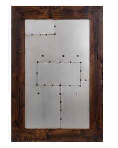 a wooden frame with metal dots on it