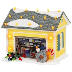 a yellow house with christmas lights on the roof and decorations around it's windows