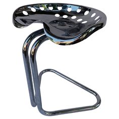 a metal object that is shaped like a bicycle seat with holes in the middle and sides