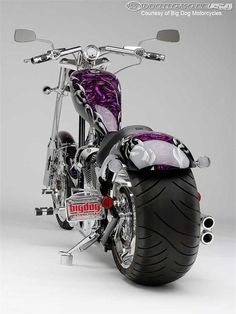 a purple motorcycle parked on top of a white floor