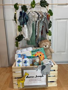 a wooden crate filled with baby items on top of a hard wood floor next to a white door