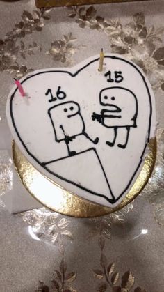 a heart shaped cake with two people on it