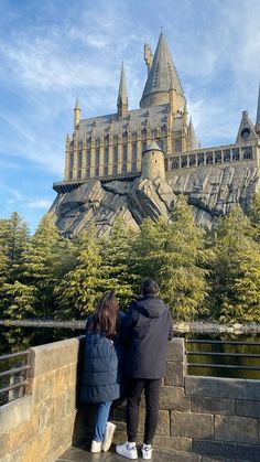 two people are looking at the hogwarts castle