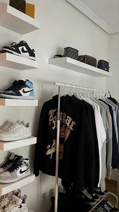 there are many shoes and shirts on the shelves