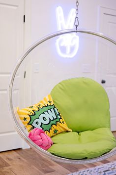 a green chair with a pillow on it and a neon sign above the chair that says pow