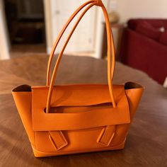 Bought Years Ago Because I Loved The Color, But Only Used A Few Times. Dust Bag Included. Some Slouching Of Leather As Shown; No Stains Or Marks. Originally Paid $3950 Not Inclusive Of Tax Product Details Medium Intreccio Leather Top Handle Bag One Interior Zipped Pocket, Two Open Pockets Flap Closure Material: 100% Calfskin Lining: Bonded Suede Color: Tangerine Hardware: Gold Finish Height: 27 Cm | 10.6" Width: 48 Cm | 18.8" Depth: 12 Cm | 4.7" Handle Drop: 22 Cm | 8.7" Made In: Italy Handle Bag, Leather Top, Womens Tote Bags, Bottega Veneta, Gold Finish, Top Handle, Calf Skin, Dust Bag, Top Handle Bag