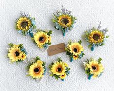 sunflowers and baby's breath flowers are arranged on a white tablecloth