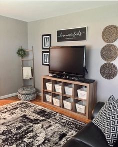 a living room with gray walls and black furniture