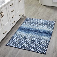 a bathroom rug with blue and white designs on the floor