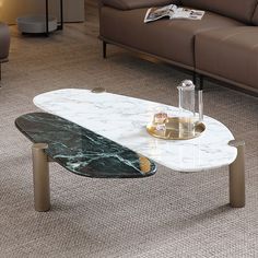 a marble coffee table sitting on top of a carpeted floor next to a couch