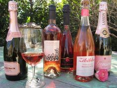 several bottles and glasses of wine sitting on a table