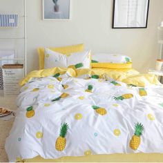 the bed has pineapples on it and yellow sheets