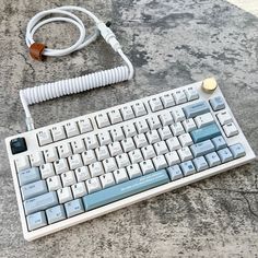 an old computer keyboard and power cord on a table with marbled surface in the background