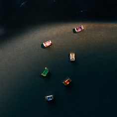 five different colored stones sitting on top of a black surface