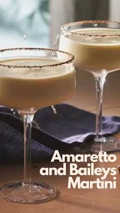 two martinis sitting next to each other on top of a wooden table with the words amarreto and bailey's martini