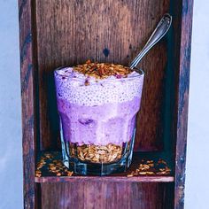 a glass filled with oatmeal sitting on top of a wooden shelf