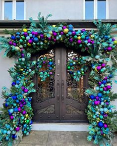 an elaborately decorated entrance to a building with christmas decorations on the front and side