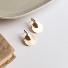 These brass earrings have a minimalist design perfect for architecture lovers. The design cosist of the intersection of a disc and a half disc. Its geometric shape is inspired by the Bauhaus movement and Moholy Nagy's paintings. Like all my jewelry, these earrings have been designed and manufactured by me in my Madrid workshop. The material of the earrings is brass with matte finish, but the post and the ear back are made of silver to avoid problems of allergic reactions. MATERIALS and FINISHES Minimalist Round Metal Earrings, Minimalist Circle Earrings As Gift, Modern Nickel-free Round Disc Earrings, Minimalist Circle Brass Earrings, Minimalist Round Brass Earrings, Minimalist Nickel-free Circular Earrings, Minimalist Nickel-free Circle Earrings, Nickel Free Minimalist Circle Earrings, Nickel-free Minimalist Circle Earrings