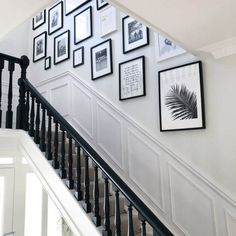 stairs with pictures on the wall above them