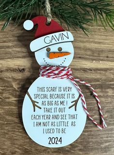 a snowman ornament hanging from a christmas tree with the saying gavin