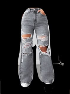 a pair of jeans with ripped knees and holes on the side, in front of a white background