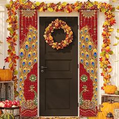 a front door decorated with fall leaves, pumpkins and other autumn decorating items