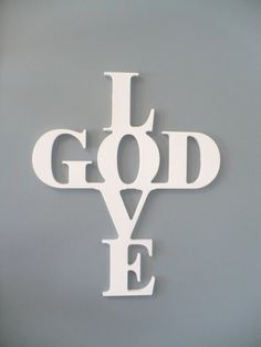 the words i love god are cut out of white paper and placed on a black background