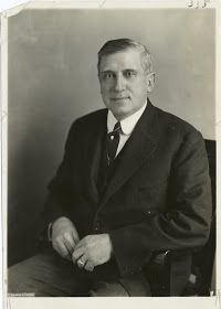 an old black and white photo of a man in a suit