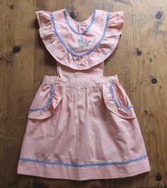 FRENCH VINTAGE 50's, beautiful littlepinafore dress / apron dress, pink cotton fabric, floral embroideries and red ric-rac detailing, two cute side pockets, buttoned in the back down to the waist ( glass buttons ). Length 18,9" Estimated size 2/3 years New old stock ( washed once ) In case of multiple purchases, if you want an accurate shipping estimation, please contact me ; I do always refund overcharged shipping from 1 Euro overpaid ! Thank you for your visit Dress Apron, Pink Apron, Cute Aprons, Cotton Apron, Apron Dress, Pink Cotton, Vintage Colors, Vintage 1950s, Floral Embroidery