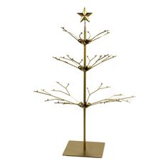 a gold metal christmas tree with branches and stars on it's top, against a white background