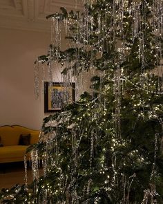 a christmas tree is decorated with lights and icicles