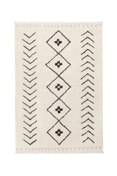 a rug with black and white designs on the front, in an off - white background