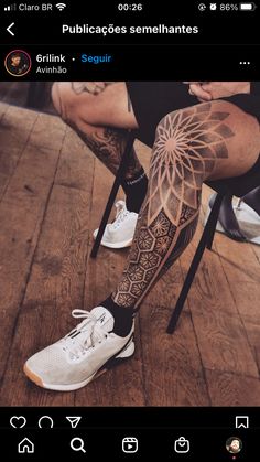 a man's leg with tattoos on it