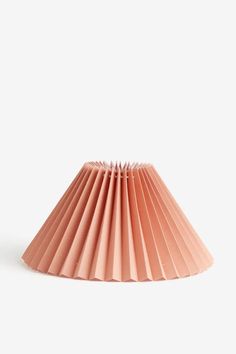 a pink paper lamp shade on a white background