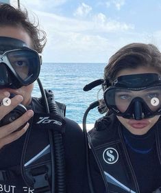 two people in scuba gear standing next to each other