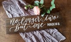 a wooden sign that says no longer two but one married