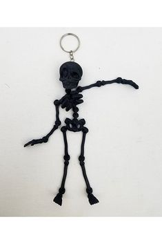 a skeleton keychain is shown on a white surface