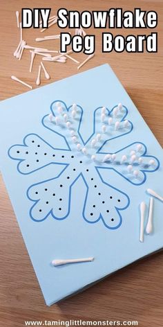 a snowflake peg board with pins and glue