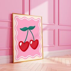 a pink room with two cherries hanging on the wall and a wooden floor in front of it