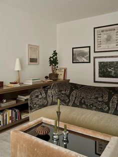 a living room filled with furniture and pictures on the wall